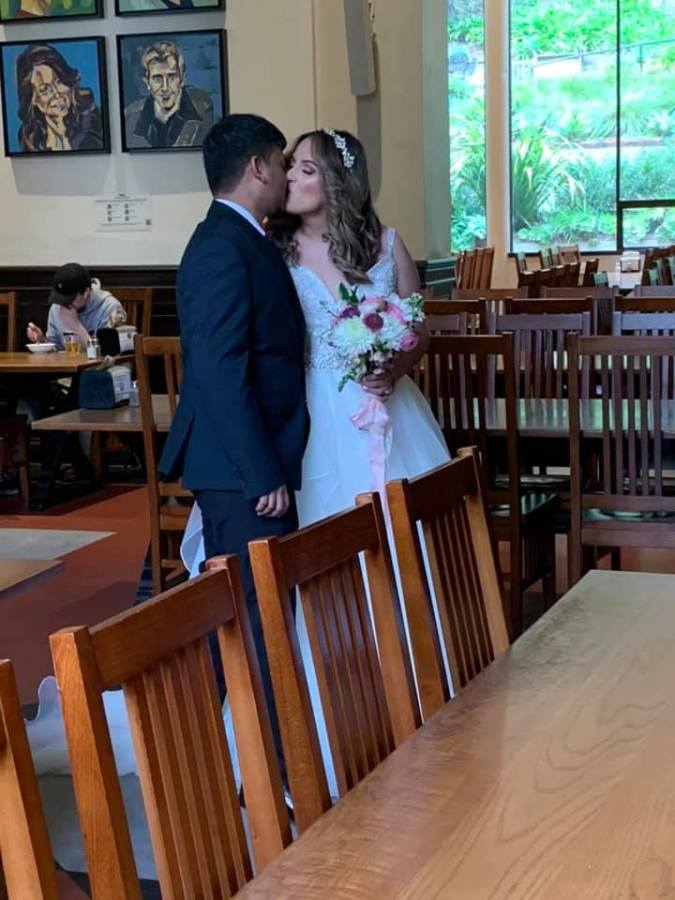 Sneaking a kiss in the place where their love blossomed (photo by Bonnie Johnston)