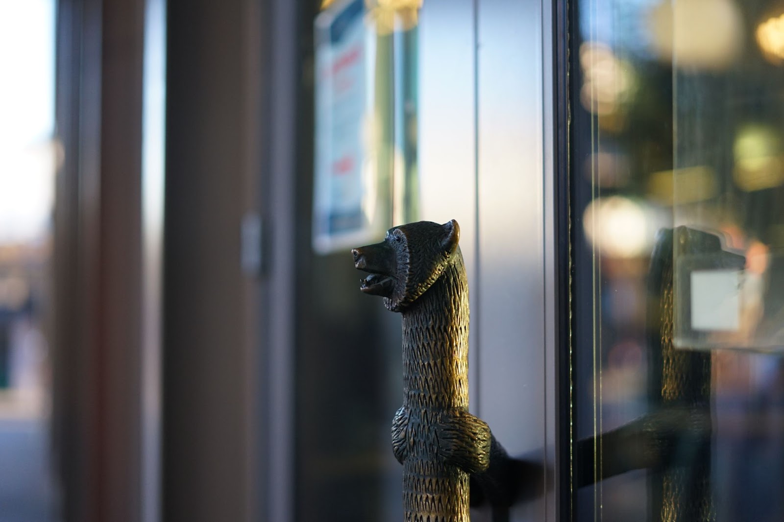 A door handle fashioned in the form of a bear. 