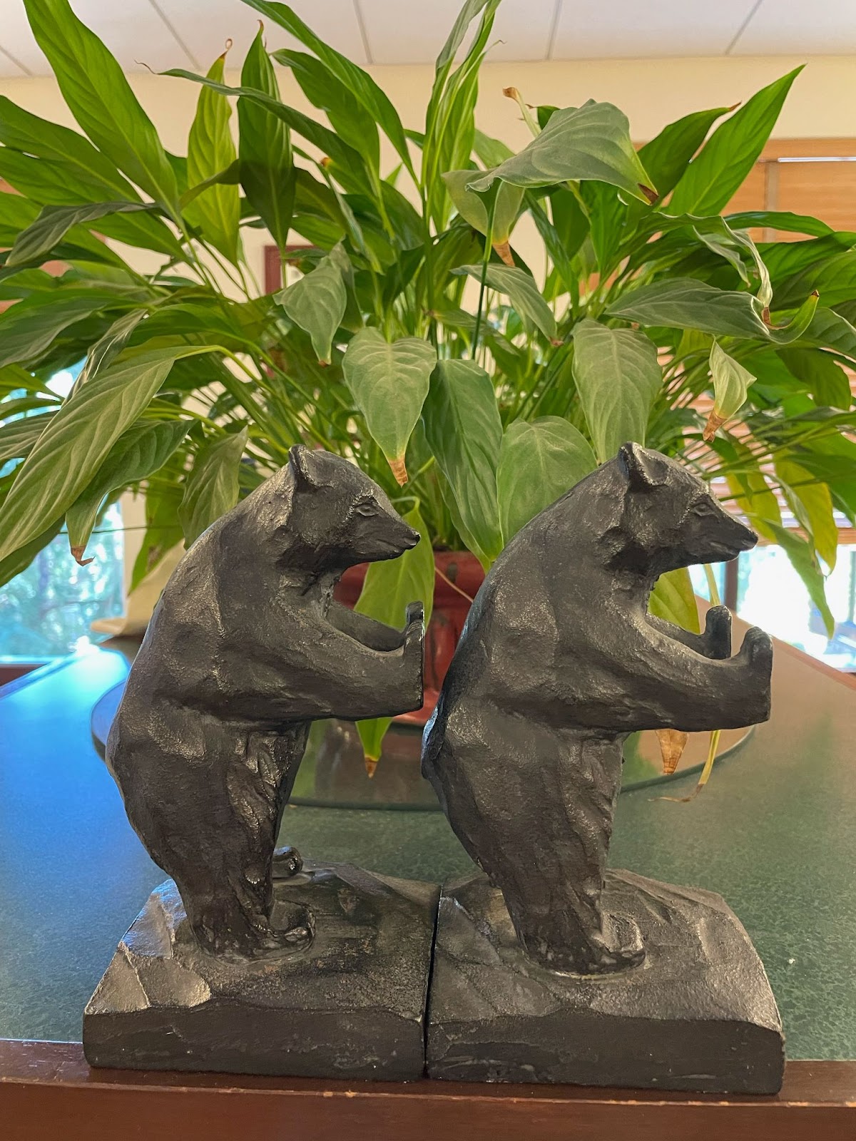 Two bear bookends with arms outstretched, facing right. 