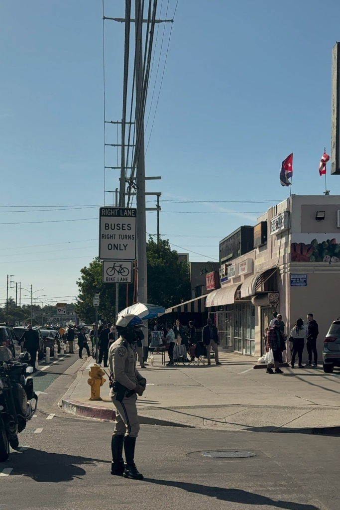 A policeman directing the traffic away from a blocked road.