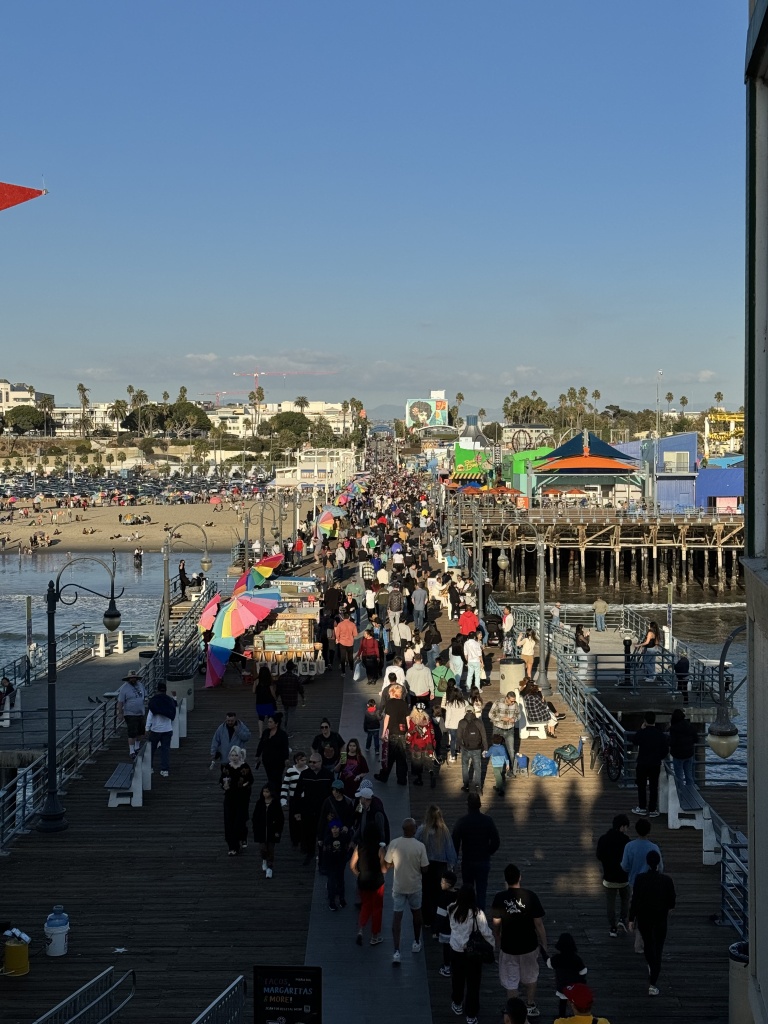 A view of the entrance of a pier with rocky hills in the backdrop.