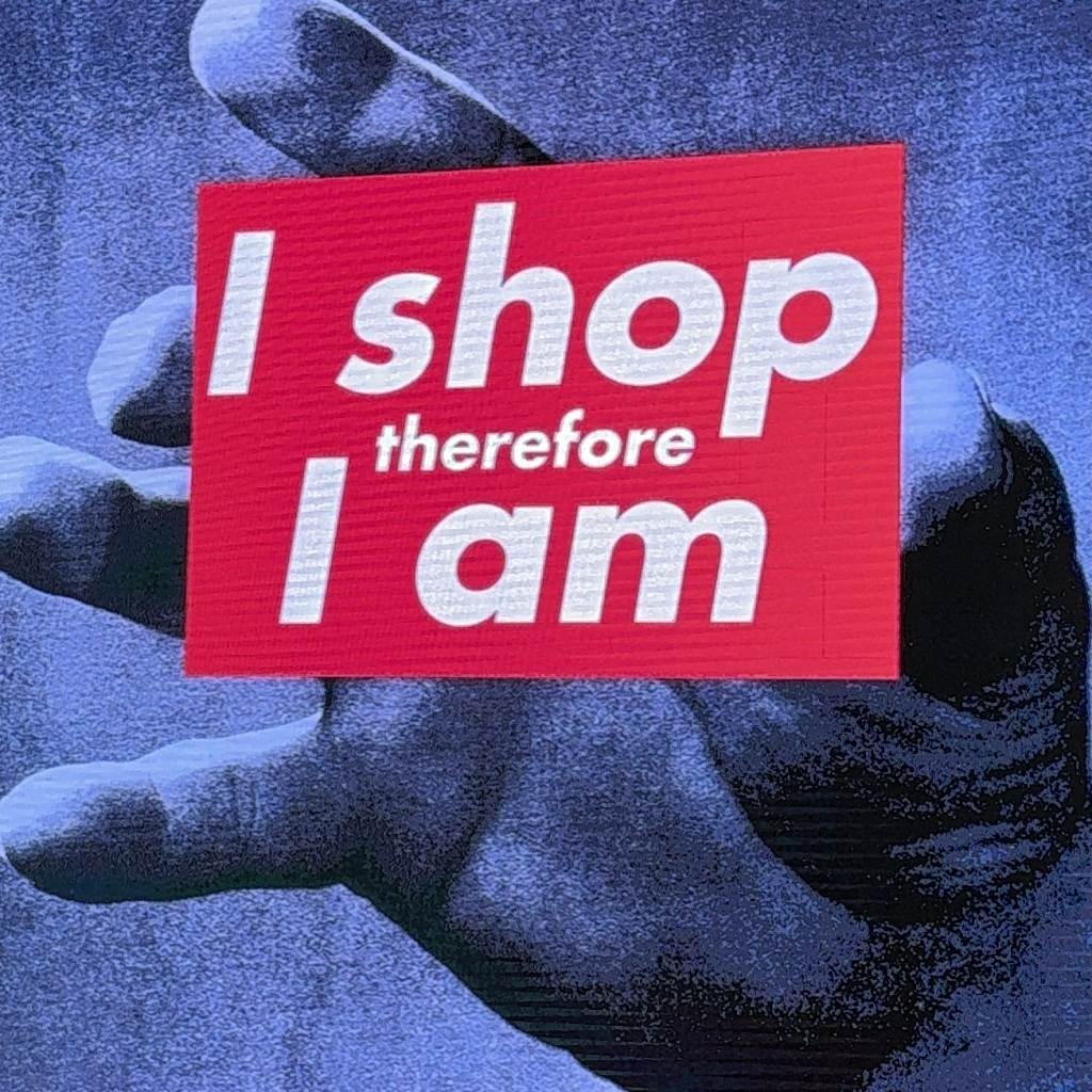 Artwork reading "I shop therefore I am".