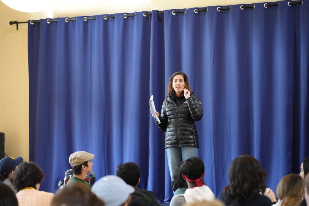 Nayeli Vivanco, Vice president for RCILP standing in front of residents on the first day of the retreat laying down some housekeeping rules.