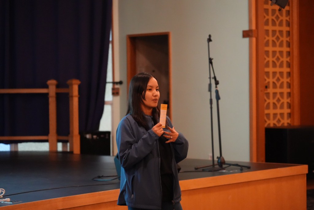 Manita Magar, Manager of RCILP, explaining the rules of the bingo card game before residents to start to play. 