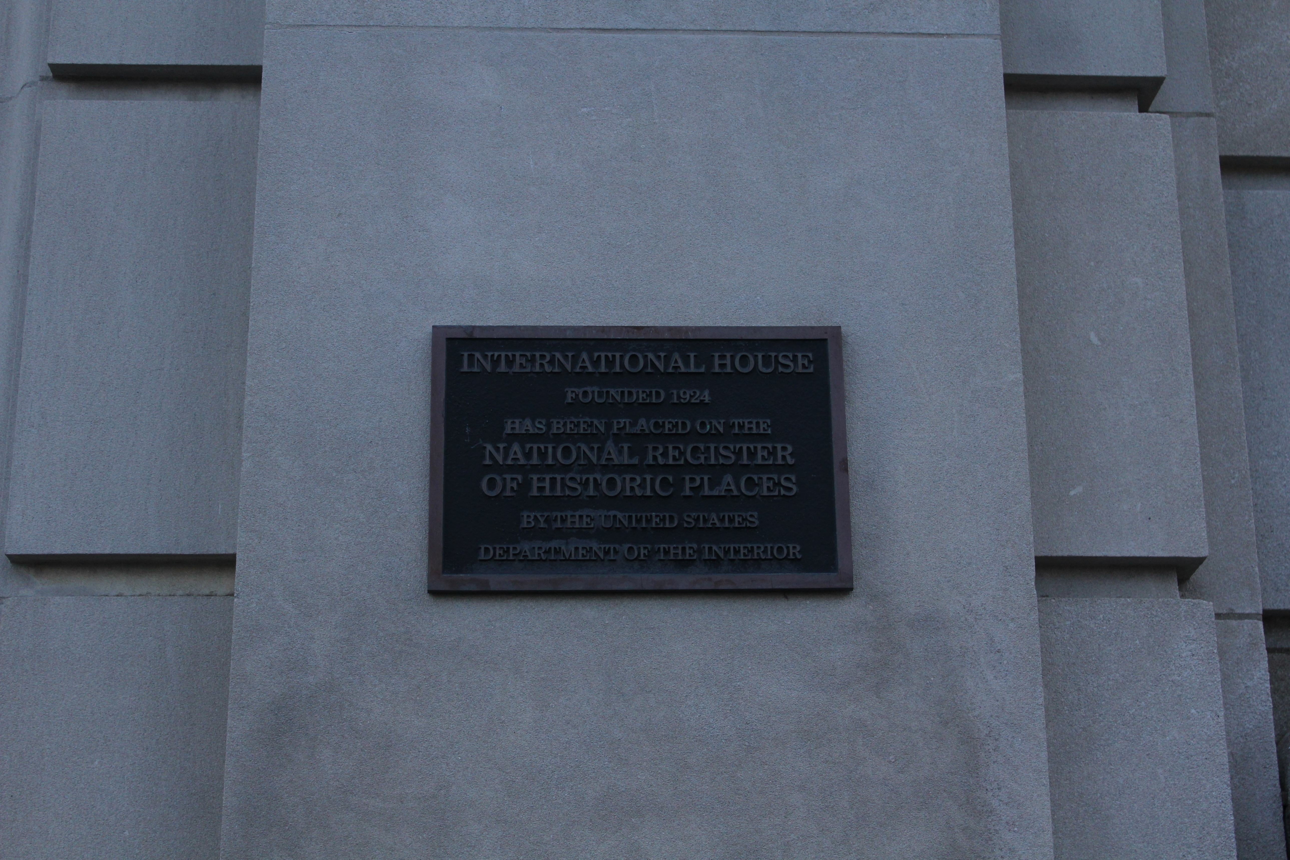 A Plaque reads "INTERNATIONAL HOUSE
FOUNDED 1924
HAS BEEN PLACED ON THE NATIONAL REGISTER
OF HISTORIC PLACES
BY THE UNITED STATES
DEPARTMENT OF THE INTERIOR"