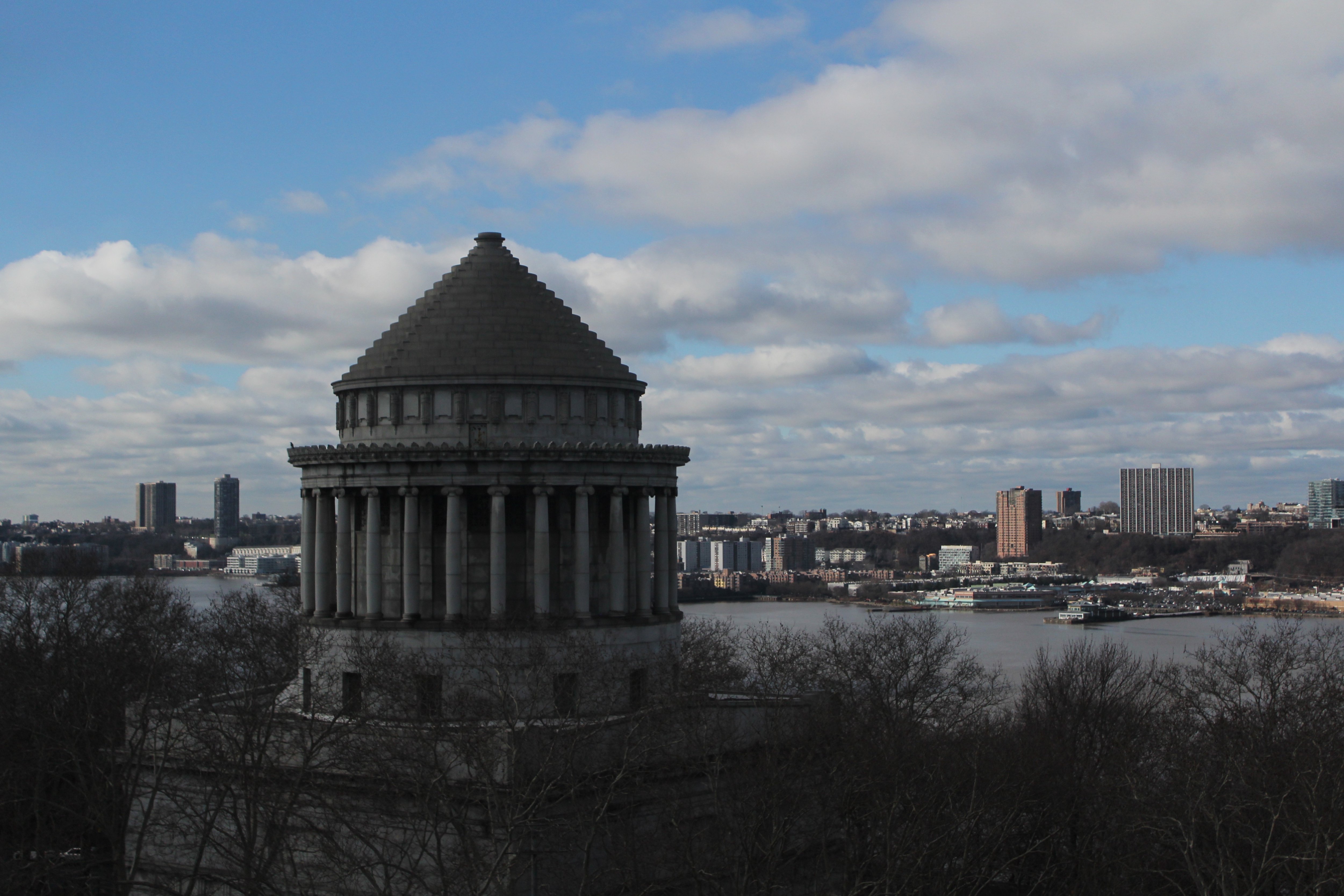 A view of a memorial building with a river in the backdrop.